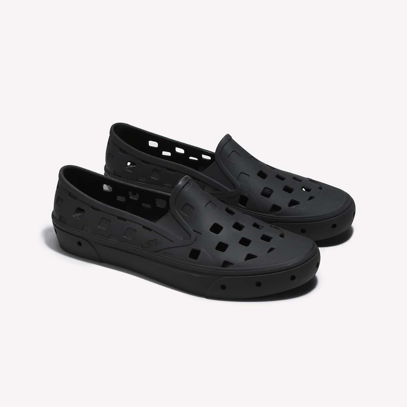 A pair of black Vans TRK slip-on shoes